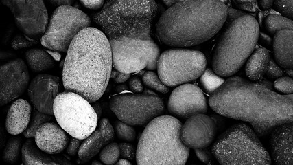 black pebbles on the beach background. black stone