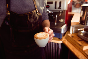 Coffee Latte Barista making pattern in a cup of coffee shop.