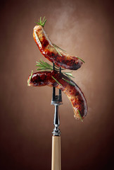 Wall Mural - Grilled Bavarian sausages with rosemary.