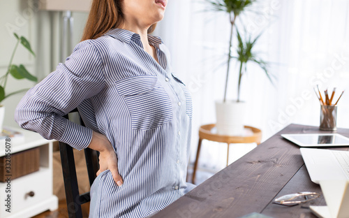 Fotografía Freelancer young woman suffering with back pain
