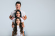© My Ocean studio - Beautiful excited and the funny family team is posing and pointing in a white t-shirt while they isolated on white background in studio.
