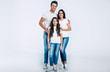 © My Ocean studio - Beautiful excited and the funny family team is posing and pointing in a white t-shirt while they isolated on white background in studio.