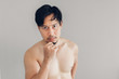 © Sevendeman - Topless Asian man is trying to be handsome.
