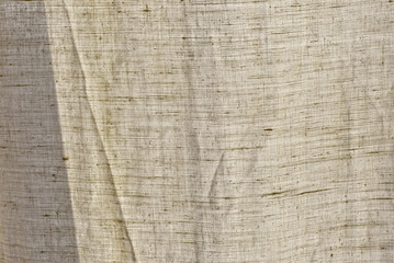 The texture of the natural old cotton fabric is exposed to sunlight.