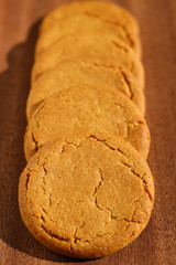 Wall Mural - A row of ginger biscuits on a dark wooden background
