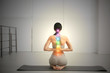 © New Africa - Young woman with chakra points practicing yoga in studio, back view. Healing energy