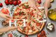 © New Africa - Food bloggers taking pictures of delicious seafood pizza at light grey table, closeup
