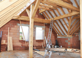 Wall Mural - Incomplete attic with roof trusses, wooden roof beams, braces and windows inside. Converting an attic into a room.