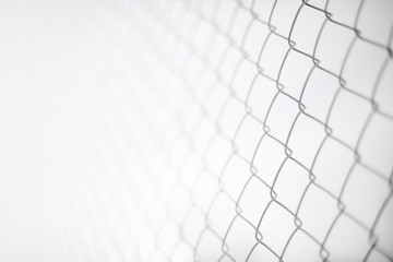 Close up rusty wire fence and blurred nature background. Wire netting or metal fence net and out of focus background