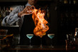 © fesenko - Bartender spray and burn alcoholic drink in wineglass.