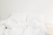 © sonyachny - Cozy white bed in the morning. White sheets and pillow on bed in modern white room. Lazy days. Stay home. Comfortable place. Relax on weekend in hotel room. Messy bed