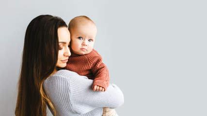 happy mother holding up her baby girl. young beautiful mother holds her baby and cuddles, motherhood