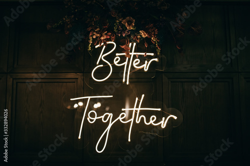 Cuadros en Lienzo Better Together - neon sign on a brick wall in a restaurant at a wedding party