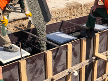 Construction Workers Are Pooring Concrete To Formwork