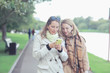 © kichigin19 - two girls look at the phone autumn walk / autumn city park coat, autumn fashion, style, look, clothes