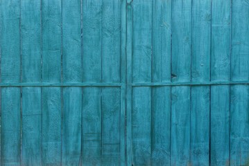 green wooden texture of  old boards in the wall of the fence