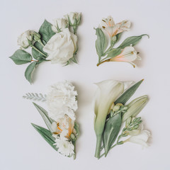 Wall Mural - creative easter layout with flowers and leaves on white paper background. spring easter holiday mini