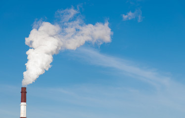 Industrial St. Petersburg - March 17, 2020 Smoking chimneys on the blue sky background. Heat station pipes, smoke.