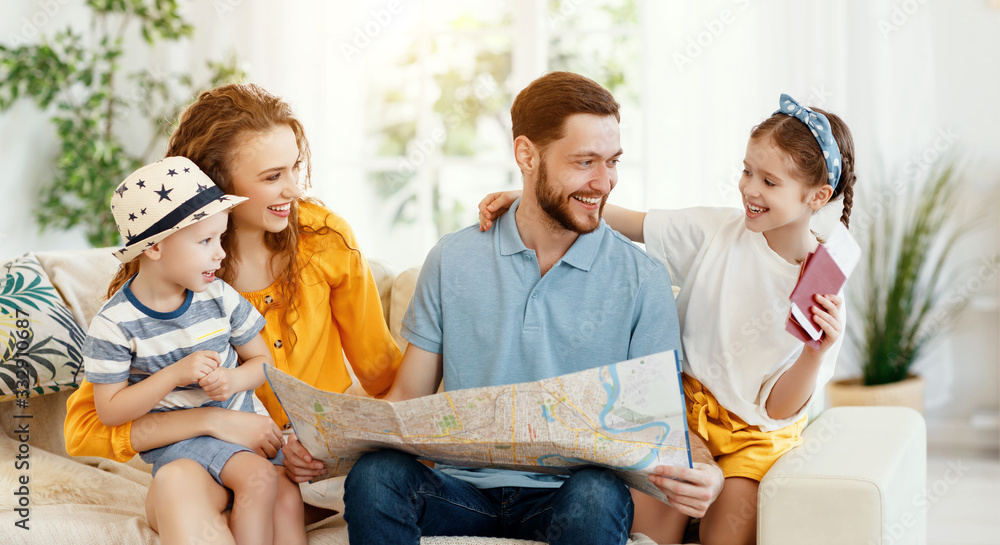 Happy family with map and passports planning travel. - obrazy, fototapety, plakaty 
