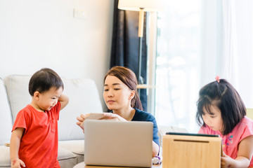 Wall Mural - Covid-19 Coronavirus and Learning from home, Home school kid concept.Little asian girl study with online learning and asian mother work from home with laptop.Quarantine and Social distancing concept.