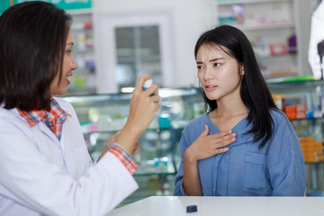 Wall Mural - female patient and doctor in pharmacy Thailand