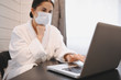 © Алина Троева - Sick woman in face medical mask working on a laptop during home quarantine isolation COVID-19 pandemic Corona virus. Distance online work from home concept. Coronavirus viral infection  symptoms