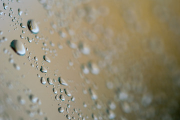 small single raindrops on a piece of glass 