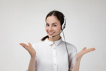 beautiful smiling woman consultant of call center in headphones on gray background. female customer 