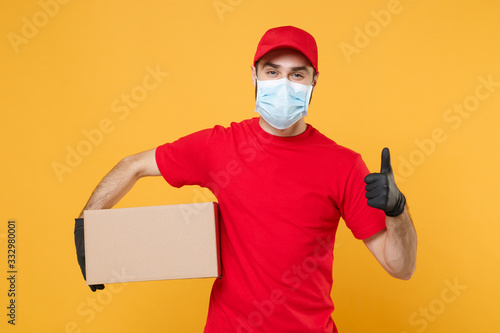 Cuadros en Lienzo Delivery man employee in red cap blank t-shirt uniform face mask glove hold empt