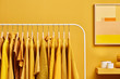 © 365mm/Stocksy - Bright clothes in yellow color on rack