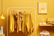 © 365mm/Stocksy - Vivid yellow wardrobe with clothes on rack