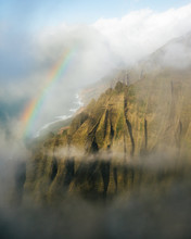 Hawaiian Rainbow Above Tall Peaks Surrounded By Fog