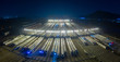 © Joseph Choi/Stocksy - High angle view of train at rail yard shunting at night