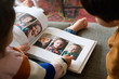 © Lauren Naefe/Stocksy - Kids looking at photographs
