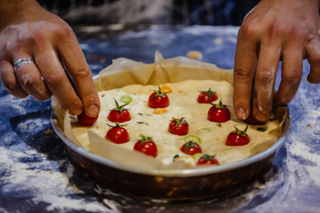 Wall Mural - Man making bread with crackling and cherry tomatoes