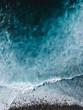 Aerial drone view of spashing waves in blue ocean
