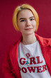 © Liliya Rodnikova/Stocksy - Pretty girl with yellow hair and t-shirt with girl power text