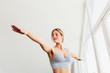 © MyMicrostock/Stocksy - Beautiful young woman doing yoga postures in luxury apartment