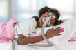 © JPC-PROD - Woman wearing CPAP headgear to sleep against apnea