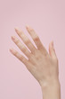 © French Anderson/Stocksy - Hand against pink background