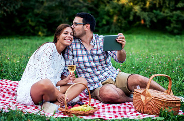 Wall Mural - Couple enjoying picnic together. Love and tenderness, dating, romance, lifestyle concept