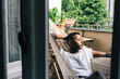 © visualspectrum/Stocksy - Woman Relaxing in Sun in Hammock