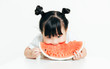© MaaHoo Studio/Stocksy - Portrait of cute girl eating watermelon with white background