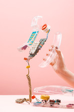 Person Holding Disassembled Transparent Plastic Phone On The Pink Background