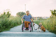 © MIHAJLO CKOVRIC/Stocksy - Happy young man in a wheelchair in his daily routine