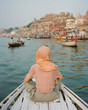 © Duet Postscriptum/Stocksy - Western woman on a boat exploring the River Ganges