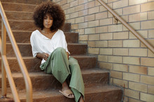 Black Woman Sitting On Steps