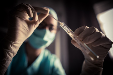 Doctor holding a coronavirus COVID-19 test tube