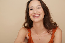 Lovely Woman Portrait Smiling In Earthy Tones Wearing Shell Jewellery