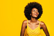 © MyMicrostock/Stocksy - Happy Afro Woman posing over yellow background